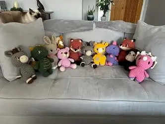 A sofa lined with handmade crochet animals